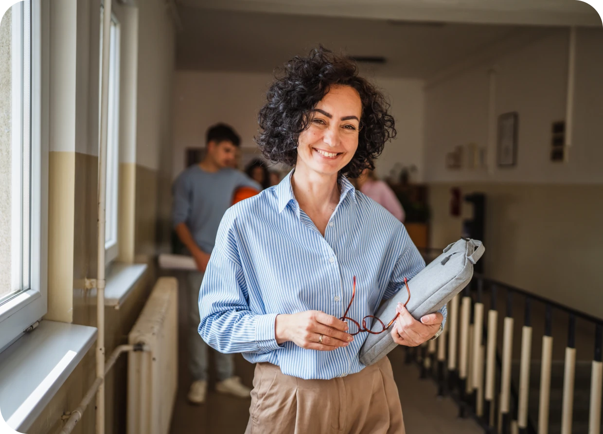 Smiling woman holding glasses and folder