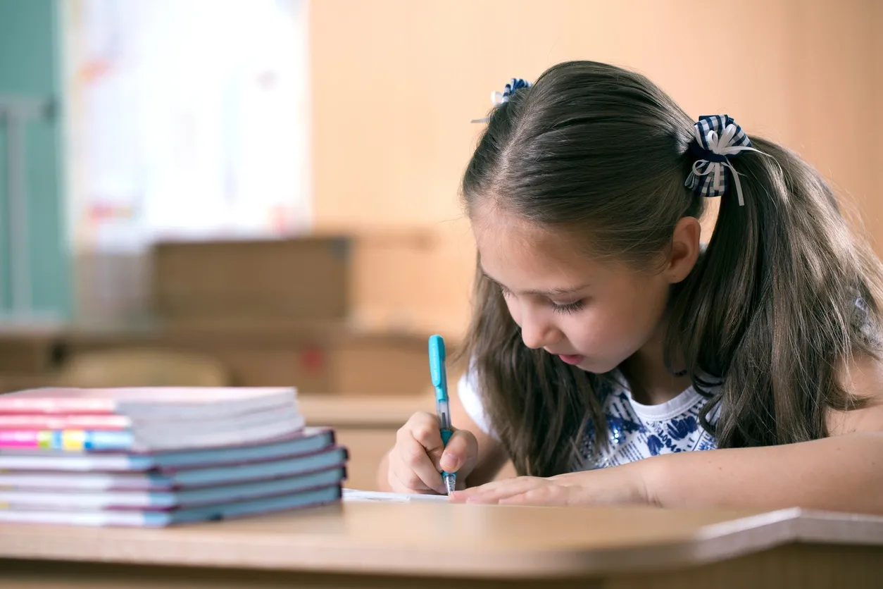 Young student focused on writing